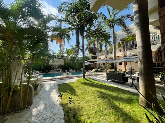 Palm-lined courtyard, pool and seating at Beond in Cancun