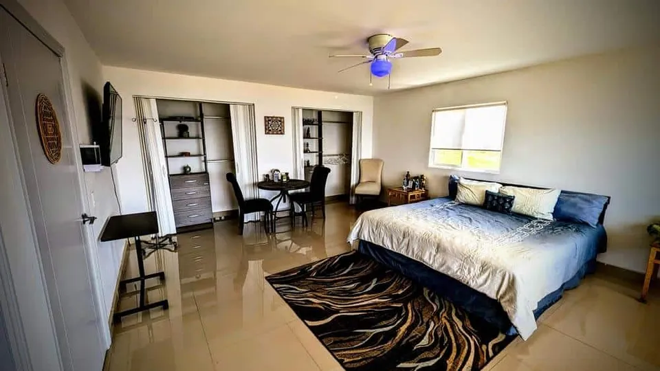 Guest bedroom with a table and chairs at Experience Ibogaine
