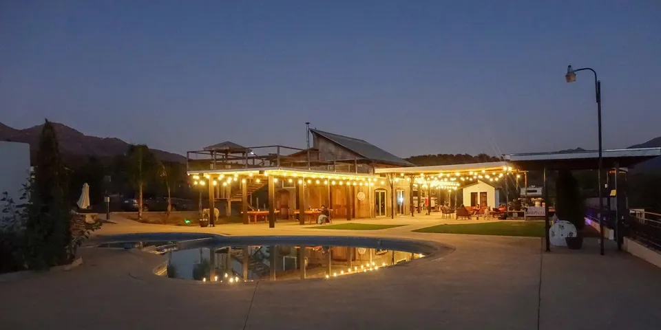 Iboga Treatment Center pool and illuminated courtyard at dusk in Ensenada