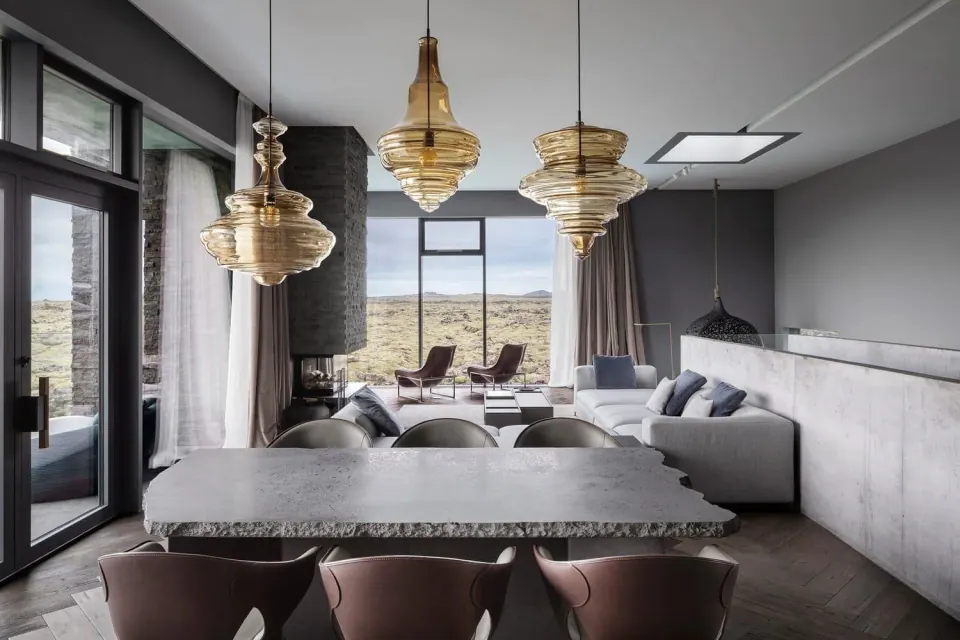 Villa living and dining room with large windows and open landscape, published on the Reykjavík program page.