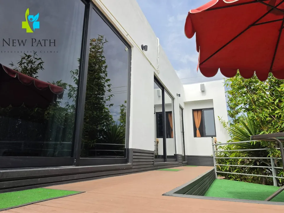 Garden deck and white guest-room buildings at New Path Ibogaine