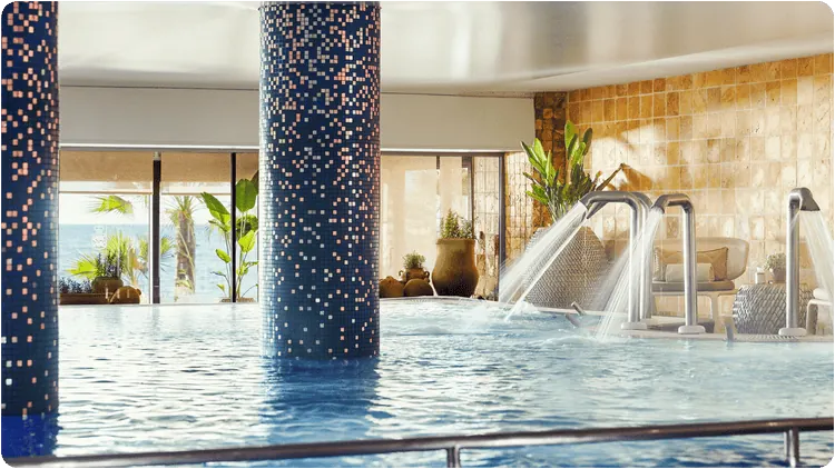 Indoor spa pool with mosaic columns, published in the Prestige accommodation gallery.